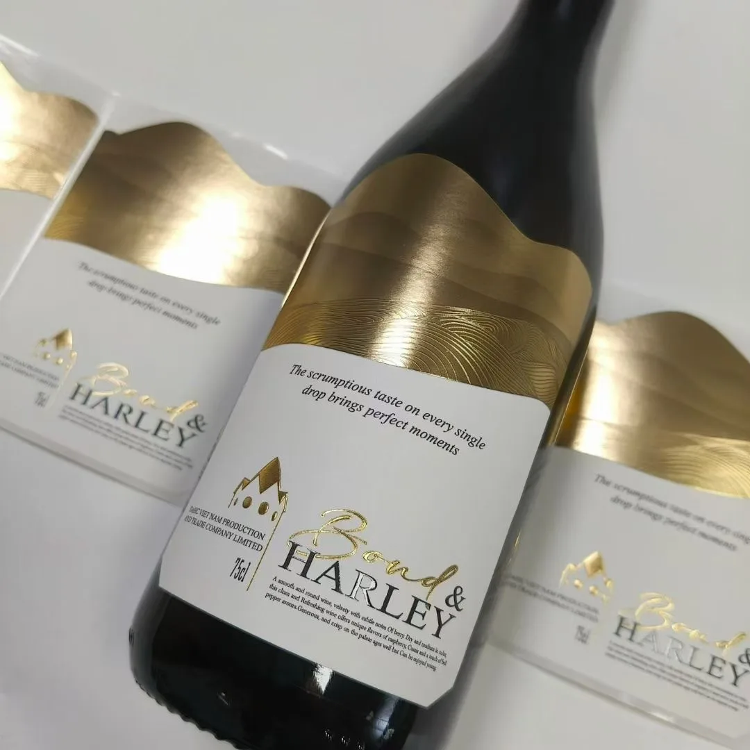 Gold foil embossed self adhesive wine bottle label with a wave die-cut edge, manufactured by Labelex